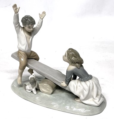 Lot 353 - A Lladro model of two children on a seesaw...