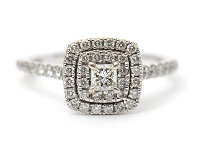 Lot 4 - An 18ct diamond halo ring, the central...