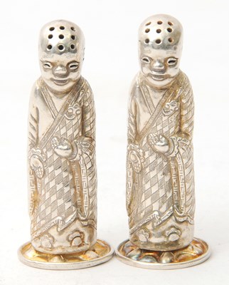 Lot 99 - A pair of white metal Chinese figural salt and...