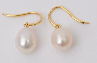 Lot 66 - A pair of cultured pearl earrings, the oval...