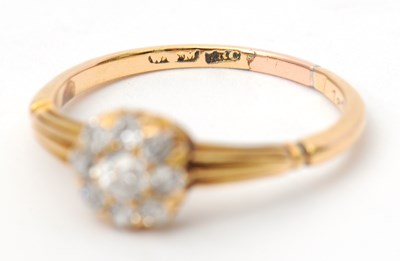Lot 39 - A diamond ring, the small round cluster set...