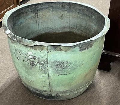 Lot 372 - A large riveted copper circular planter with...