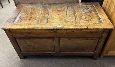 Lot 376 - An 18th Century oak coffer with panelled top...