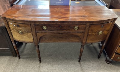 Lot 444 - A late Georgian mahogany bow front sideboard...