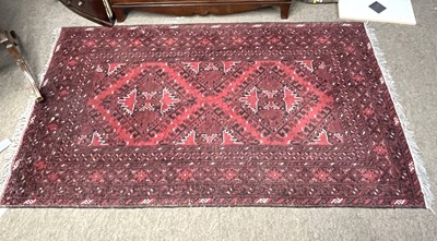 Lot 463 - A small Afghan rug with a panel of lozenges on...