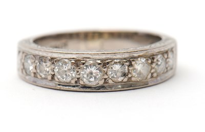 Lot 16 - A half eternity diamond ring, set with round...