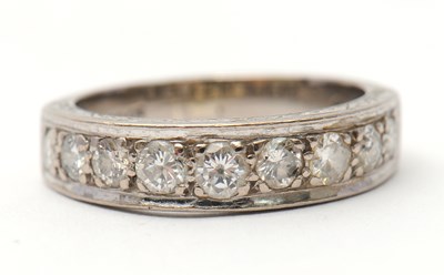 Lot 16 - A half eternity diamond ring, set with round...