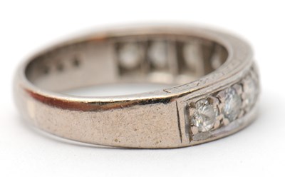 Lot 16 - A half eternity diamond ring, set with round...
