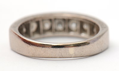 Lot 16 - A half eternity diamond ring, set with round...