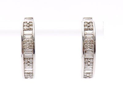 Lot 59 - A pair of 18ct diamond earrings, the hinged...