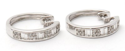 Lot 59 - A pair of 18ct diamond earrings, the hinged...