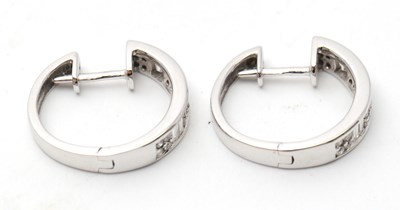 Lot 59 - A pair of 18ct diamond earrings, the hinged...