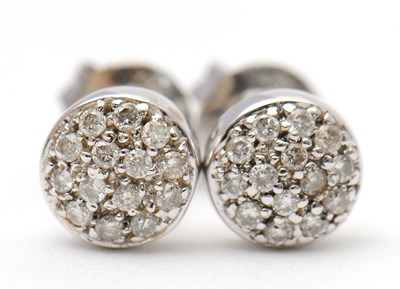 Lot 42 - A pair of diamond earrings, the slightly domed...