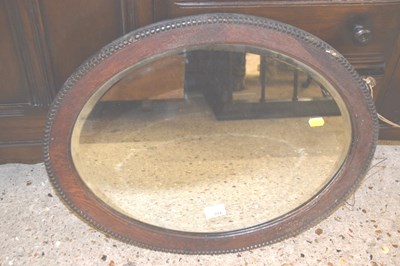 Lot 334 - Early 20th Century oval wall mirror in oak frame