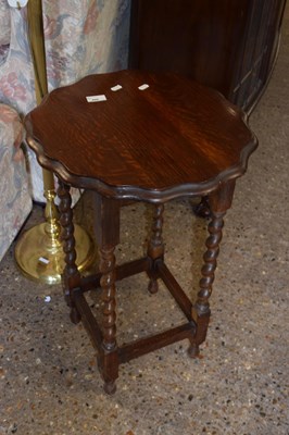 Lot 406 - An oak lamp table on barley twist legs
