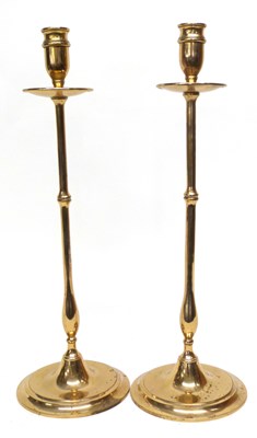 Lot 412 - Pair of brass candlesticks of slim baluster...