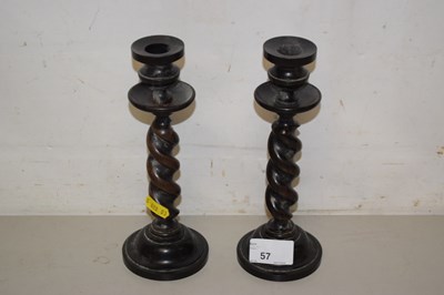 Lot 57 - Pair of turned wood candlesticks