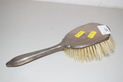 Lot 107 - A silver backed hairbrush