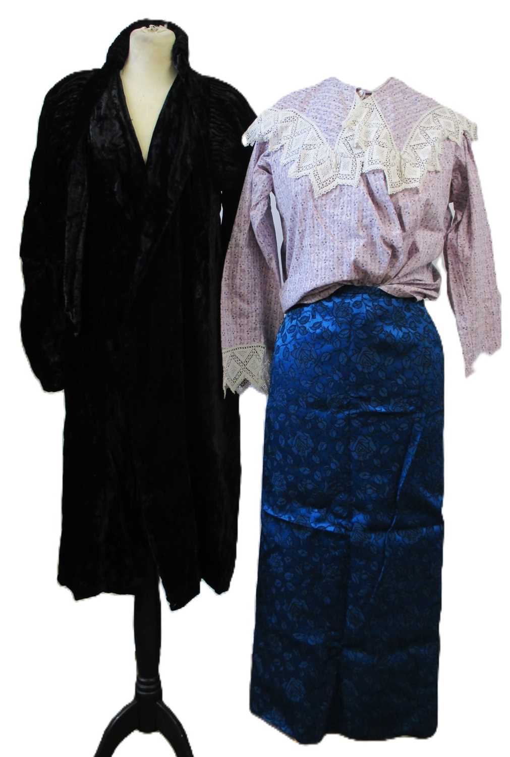 Lot 14 - An early 20th century black velvet coat with...