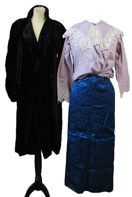 Lot 14 - An early 20th century black velvet coat with...