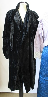 Lot 14 - An early 20th century black velvet coat with...
