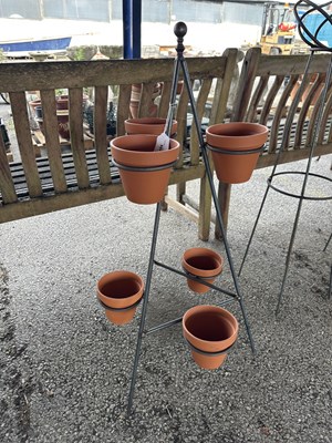 Lot 197 - A metal plant pot stand, complete with six...