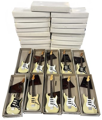 Lot 150 - Box of miniature replica fender guitars...