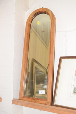 Lot 36 - A small arch top mirror