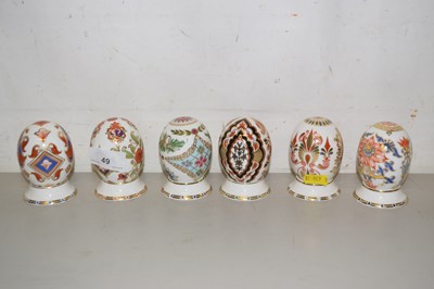 Lot 49 - A set of six Royal Crown Derby eggs with stands