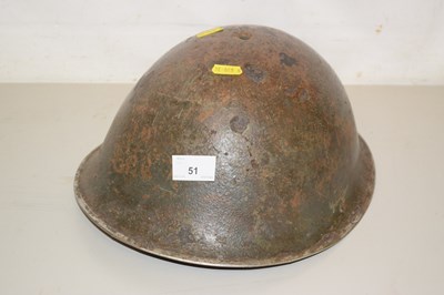 Lot 51 - A Second World War army helmet, weathered...