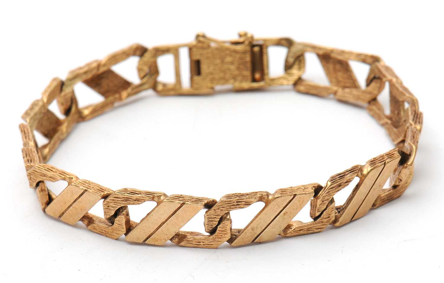 Lot 85 - A 9ct curblink bracelet, with smooth and...