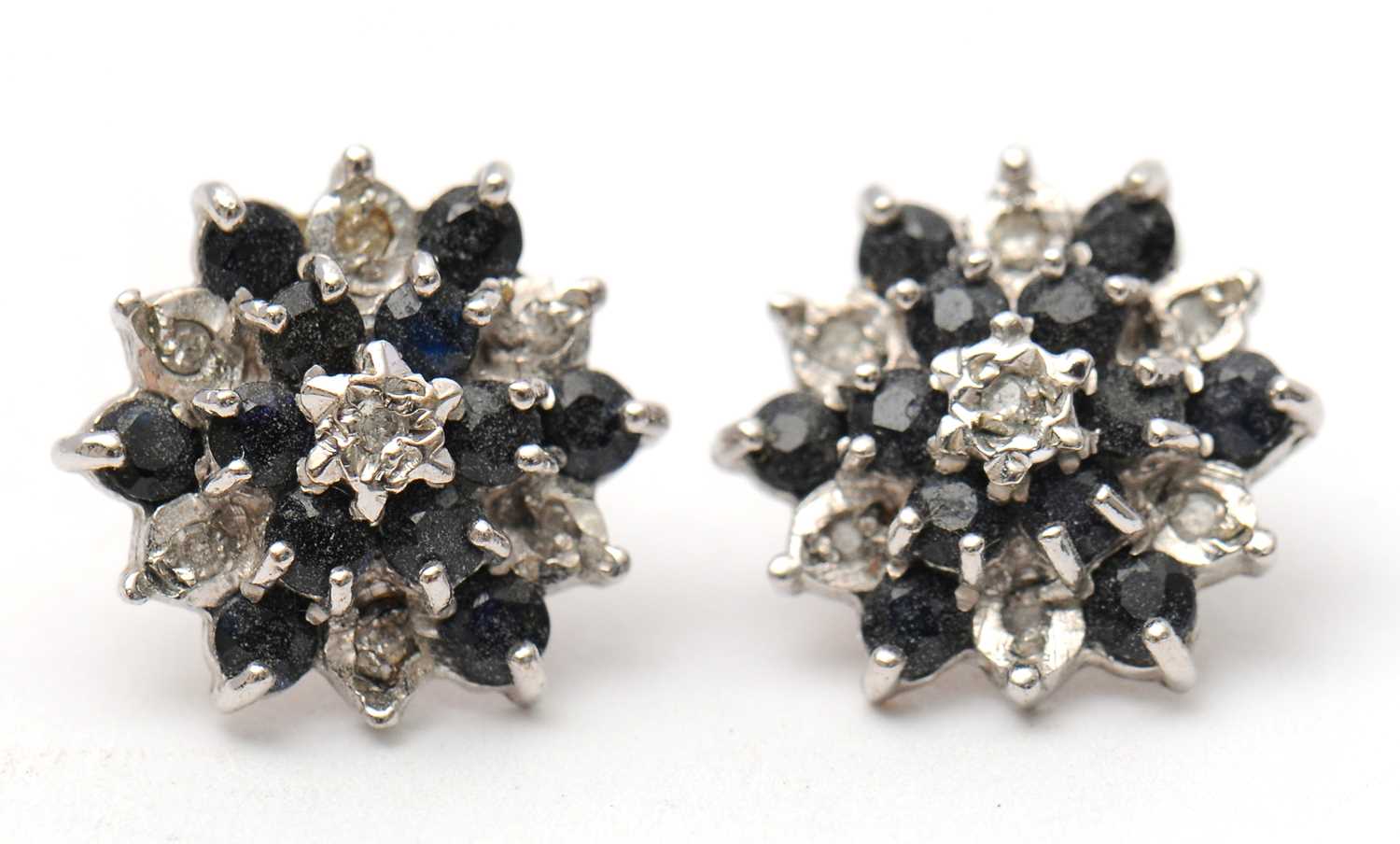 Lot 56 - A pair of 9ct sapphire and diamond earstuds,...