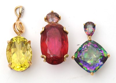 Lot 63 - Three 9ct gemset pendants: to include an oval...