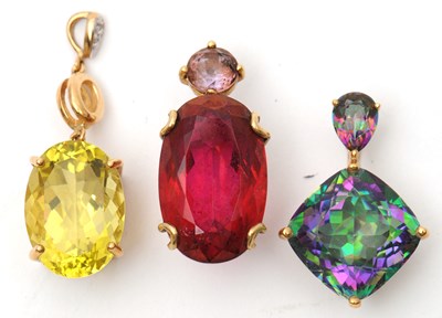 Lot 63 - Three 9ct gemset pendants: to include an oval...