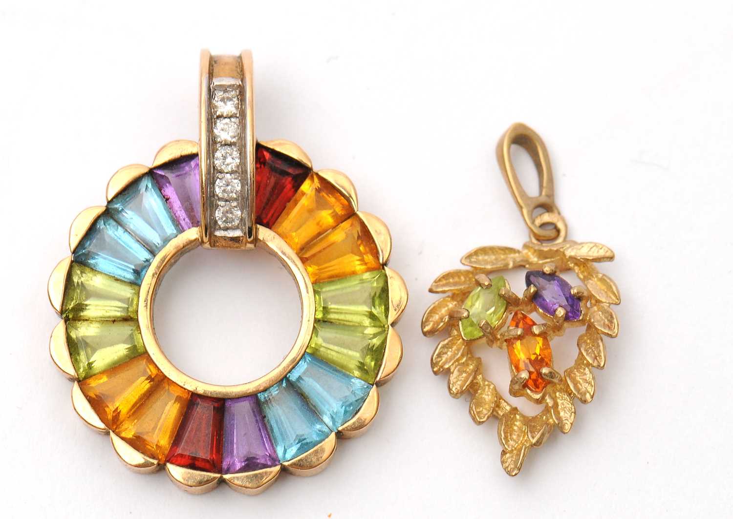Lot 57 - Two gemset pendants: to include a 9ct multi...