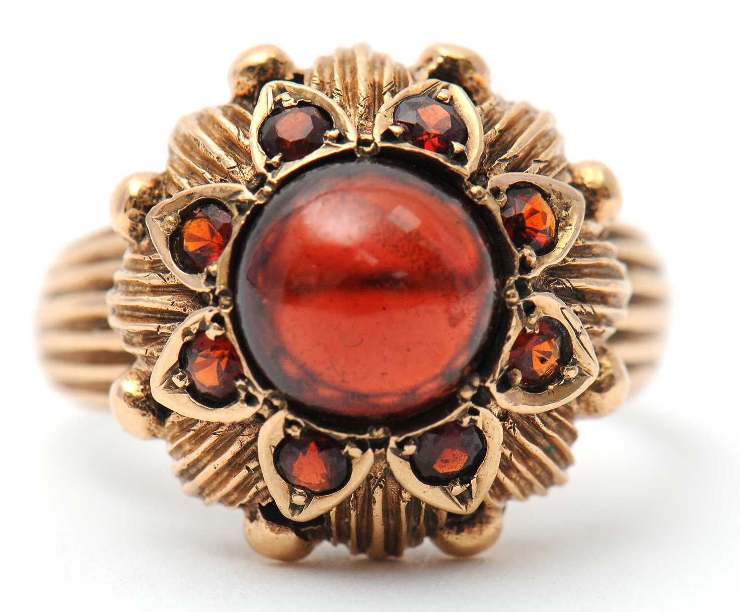 Lot 22 - A garnet dress ring, with central round garnet...