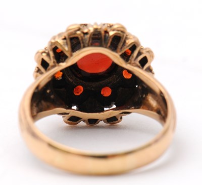 Lot 22 - A garnet dress ring, with central round garnet...