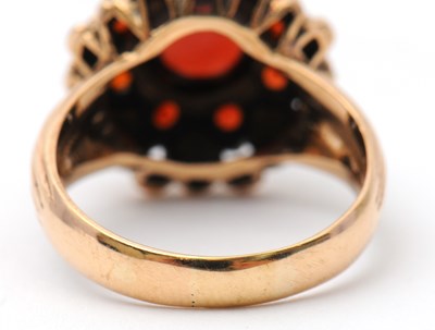 Lot 22 - A garnet dress ring, with central round garnet...