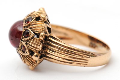 Lot 22 - A garnet dress ring, with central round garnet...