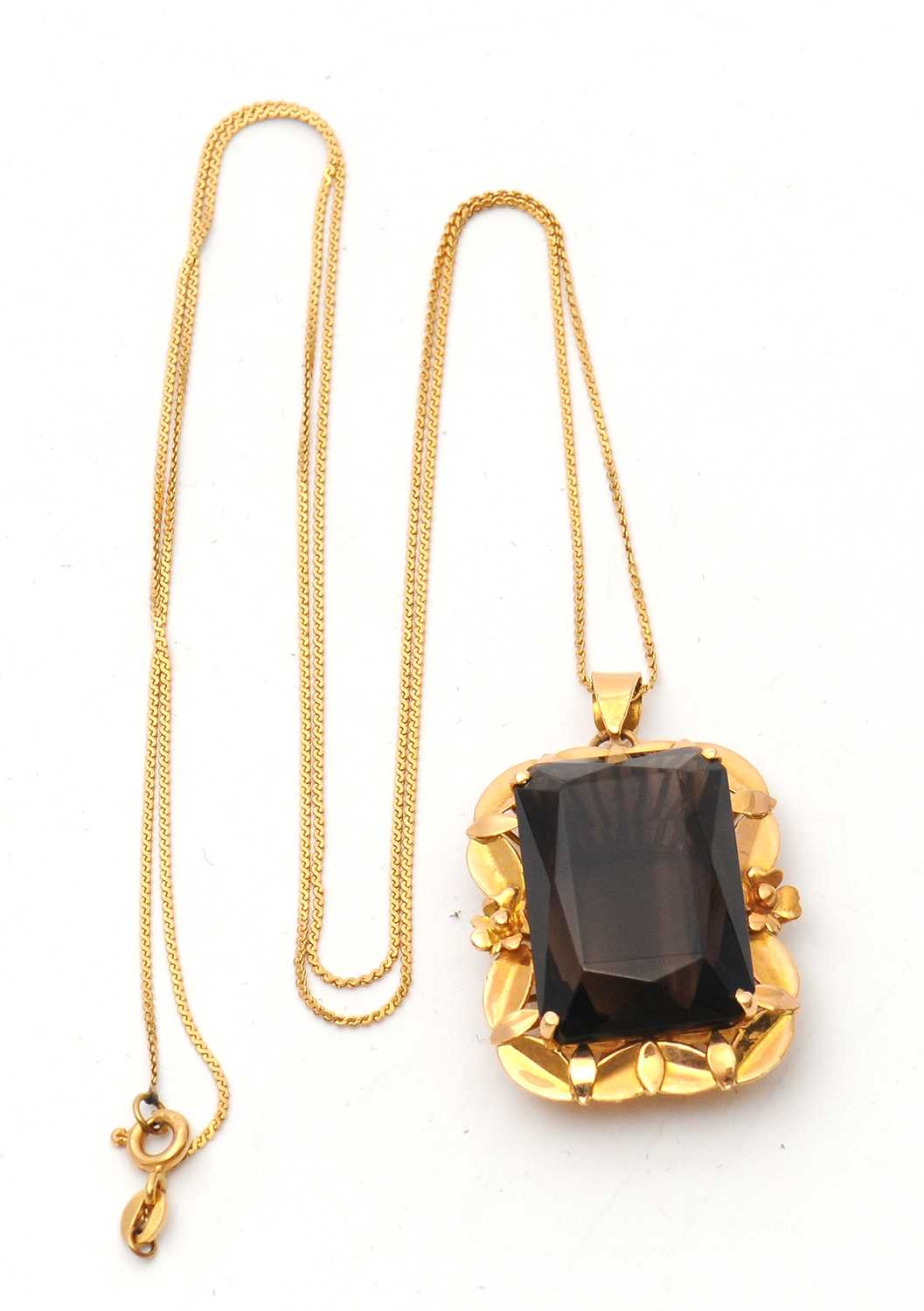 Lot 52 - A smokey quartz pendant and chain, the pendant...