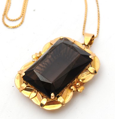 Lot 52 - A smokey quartz pendant and chain, the pendant...
