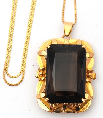 Lot 52 - A smokey quartz pendant and chain, the pendant...