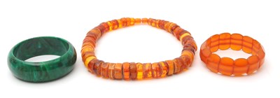 Lot 147 - An amber bead necklace, with irregular disc...
