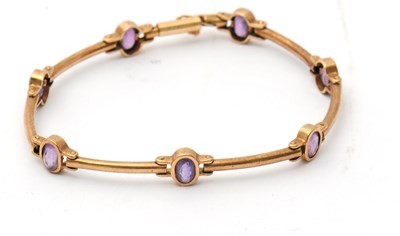 Lot 109 - An amethyst bracelet, with collet mounted oval...