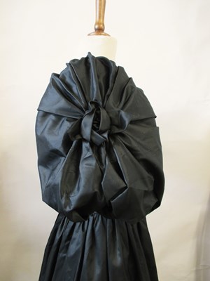 Lot 56 - John Charles: a 1980's black satin gown, with...