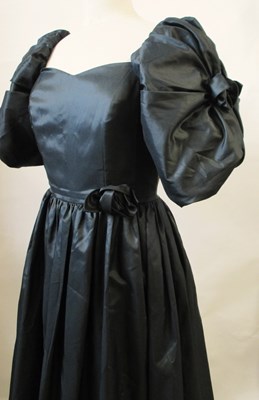 Lot 56 - John Charles: a 1980's black satin gown, with...
