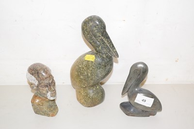 Lot 49 - A group of three carved soapstone figures, the...
