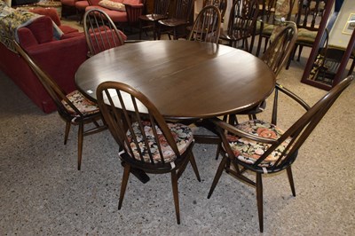 Lot 245 - An Ercol dark finish drop leaf table and six...