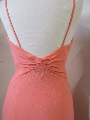 Lot 87 - Two dresses, including an apricot chiffon...