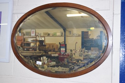 Lot 229 - An oval bevelled wall mirror
